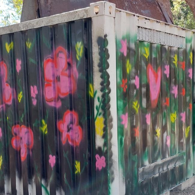 Couran Cove residents have painted over a disturbing message that was written on a shipping container.