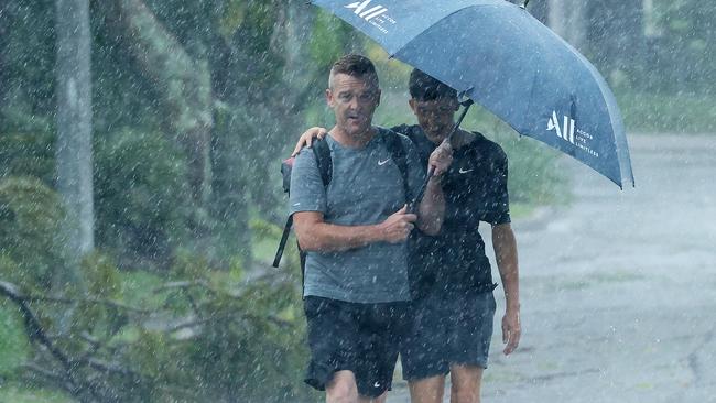 Port Douglas residents dealing with the rain after TC Jasper made landfall. Picture: Liam Kidston