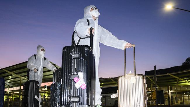 International arrivals leave Sydney International Airport, headed for quarantine. Picture: Darren Leigh Roberts