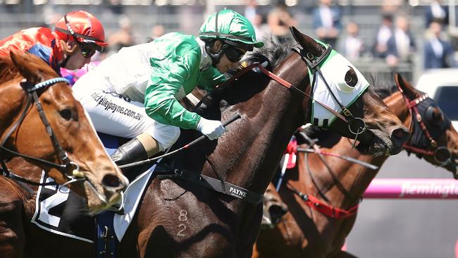 Michelle Payne and Tavi Bay (green silks) charge out of the pack to salute on Oaks Day at Flemington. Picture: Wayne Ludbey