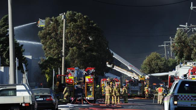 Black day: Firefighters battle the blaze, which blanketed the area in thick smoke. Picture: Andrew Henshaw