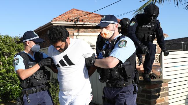 Police arrest Ali Elmoubayed in an early morning raid at a Merrylands home. Picture: John Grainger