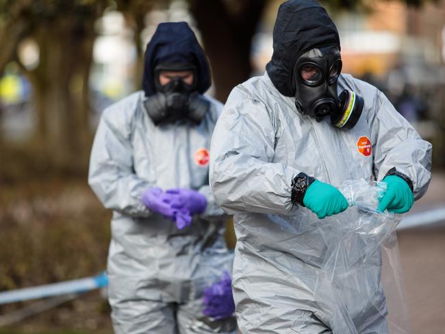 Police officers in protective suits and masks work near the scene where former double-agent Sergei Skripal and his daughter, Yulia were discovered after being attacked with a nerve-agent in Salisbury, England. Picture: Getty