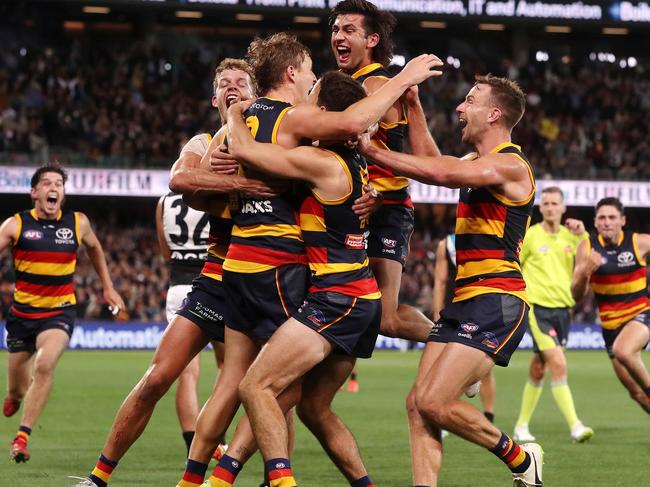 ADELAIDE, AUSTRALIA - APRIL 01: Players surround Jordan Dawson of the Crows after kicking the winning goal during the 2022 AFL Round 03 match between the Adelaide Crows and the Port Adelaide Power at Adelaide Oval on April 01, 2022 In Adelaide, Australia. (Photo by Sarah Reed/AFL Photos via Getty Images)