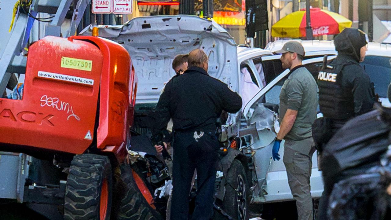 Police investigators surround a white truck that it's thought was used to run over scores of people in New Orleans. (Photo by Matthew HINTON / AFP)