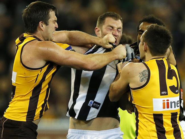 Brian Lake and Luke Hodge get in Travis Cloke’s face. Picture: Wayne Ludbey