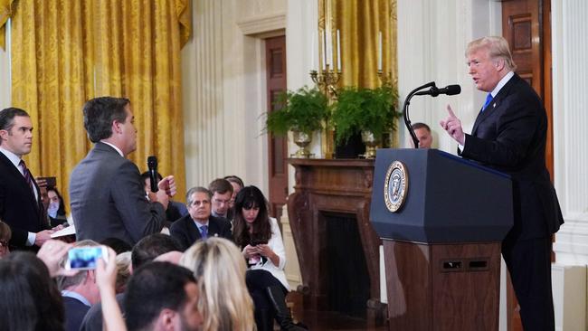 US President Donald Trump (R) gets into a heated exchange with CNN chief White House correspondent Jim Acosta (C) as NBC correspondent Peter Alexander (L) looks on during a post-election press conference. Picture: AFP