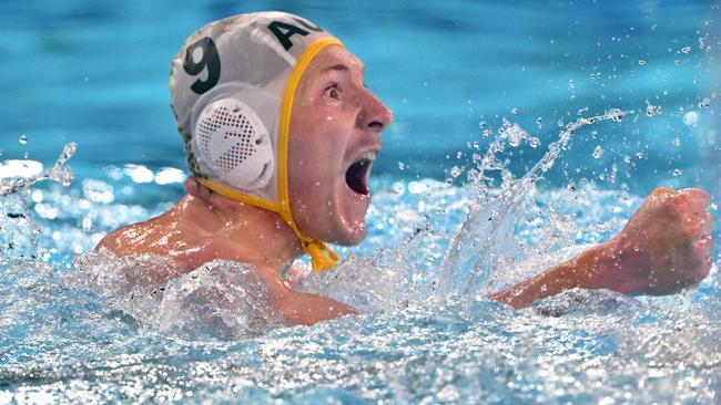 Australia's #09 Matthew Byrnes celebrates after scoring in the men's water polo preliminary round group B match between Australia and Serbia during the Paris 2024 Olympic Games at the Aquatics Centre in Saint-Denis, north of Paris, on July 30, 2024. (Photo by Andreas SOLARO / AFP)