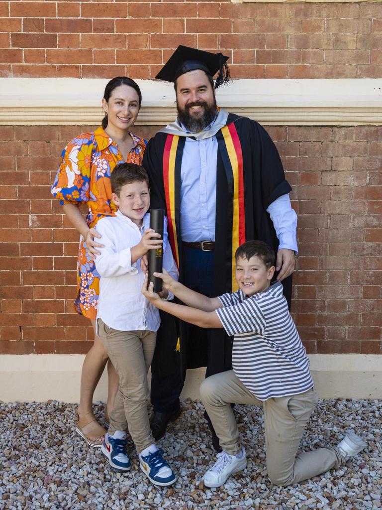 Caine Hanshaw celebrates his Master of Business Administration graduation with family Yasmine, Zavier (left) and Levi Hanshaw at the UniSQ graduation ceremony at Empire Theatres, Wednesday, December 14, 2022.