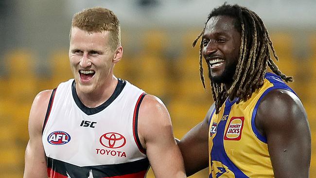 BRISBANE, AUSTRALIA - JULY 11: Reilly O'Brien of the Crows and Nic Naitanui of the Eagles share a joke at the end of the match during the round 6 AFL match between the West Coast Eagles and the Adelaide Crows at The Gabba on July 11, 2020 in Brisbane, Australia. (Photo by Jono Searle/AFL Photos/via Getty Images)