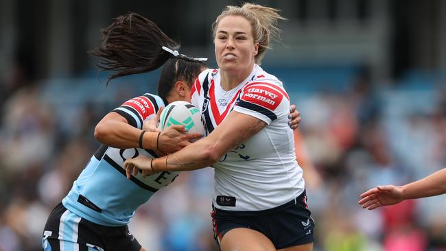 SYDNEY, AUSTRALIA - SEPTEMBER 08: Isabelle Kelly of the Roosters is tackled during the round seven NRLW match between Cronulla Sharks and Sydney Roosters at PointsBet Stadium on September 08, 2024 in Sydney, Australia. (Photo by Mark Metcalfe/Getty Images)