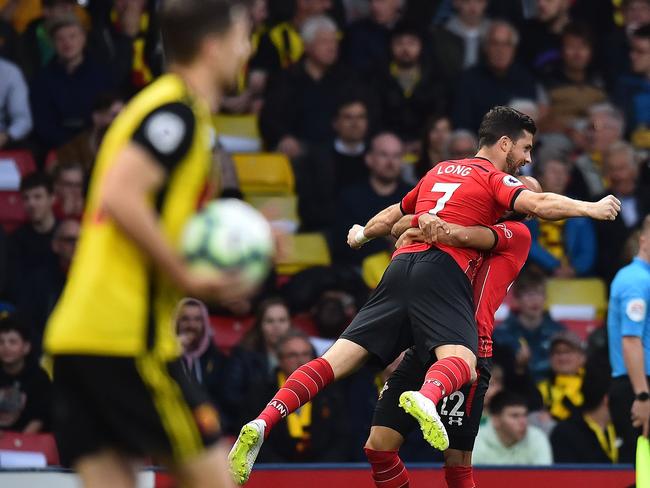 Southampton's Irish striker Shane Long celebrates scoring the opening goal with Southampton's English midfielder Nathan Redmond (R) during the English Premier League football match between Watford and Southampton at Vicarage Road Stadium in Watford, north of London on April 23, 2019. (Photo by Glyn KIRK / AFP) / RESTRICTED TO EDITORIAL USE. No use with unauthorized audio, video, data, fixture lists, club/league logos or 'live' services. Online in-match use limited to 120 images. An additional 40 images may be used in extra time. No video emulation. Social media in-match use limited to 120 images. An additional 40 images may be used in extra time. No use in betting publications, games or single club/league/player publications. /