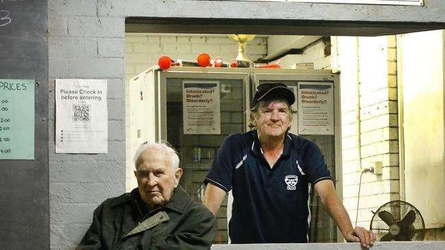 Ardmona Cats life members Greg Wilson (seated) with his son Les Wilson behind the bar. Picture: David Caird