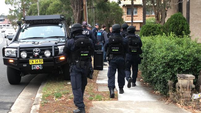 Tactical police on the scene in south west Sydney where homes were raided this morning. Picture: TNV