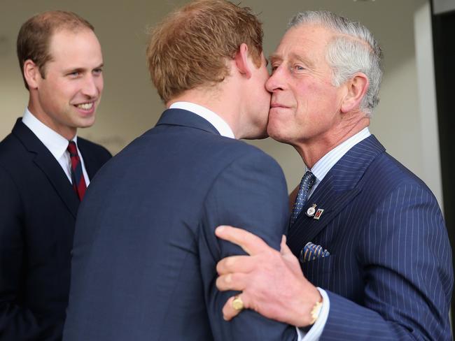 LONDON, ENGLAND - SEPTEMBER 10:  Prince Charles, Prince of Wales kisses his son Prince Harry as Prince William, Duke of Cambridge looks on ahead of the Invictus Games Opening Ceremony at Queen Elizabeth II Park on September 10, 2014 in London, England. The International sports event for 'wounded warriors', presented by Jaguar Land Rover, is just days away with limited last-minute tickets available at www.invictusgames.org  (Photo by Chris Jackson/Getty Images)