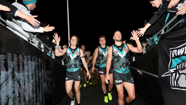 Port Adelaide players leave the ground after their win over Richmond. Picture: James Elsby/Getty Images