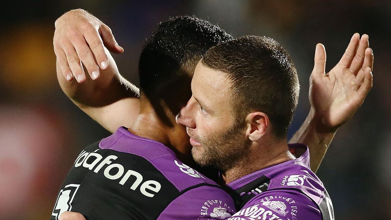 Blake Green and Roger Tuivasa-Sheck of the Warriors share a hug after winning the round 22 against the Knights.