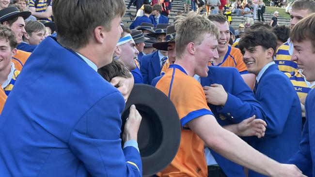 Marist College centre outside back Tom Howard is congratulated by school mates.