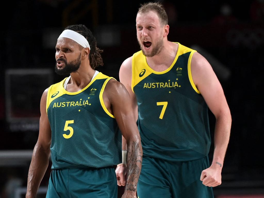 Basketball brothers Patty Mills and Joe Ingles fire up during their Tokyo bronze medal triumph. Picture: AFP