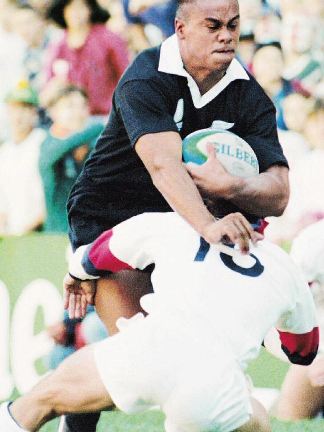 Jonah Lomu uses Mike Catt as a doormat.