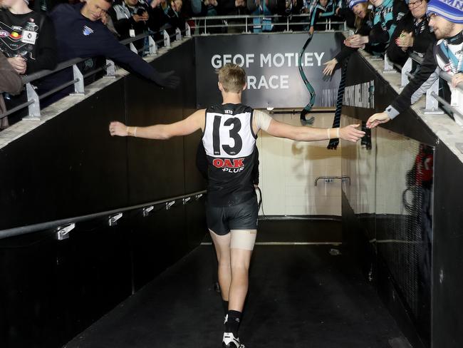 14/06/18 - AFL - Port Adelaide v Western Bulldogs at The Adelaide Oval. After an emotional first game back after the death of his father Todd Marshall walks down the race to gather himself before walking off with his team. Picture SARAH REED