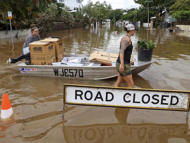 BRISBANE, AUSTRALIA - MARCH 03: People use a boat to save items from their home at Torwood Street, Auchenflower on March 03, 2022 in Brisbane, Australia. From Brisbane in Queensland to Lismore in northern New South Wales, flood-affected communities are cleaning up debris as the weather system moves south towards Sydney. (Photo by Peter Wallis/Getty Images) ***BESTPIX***