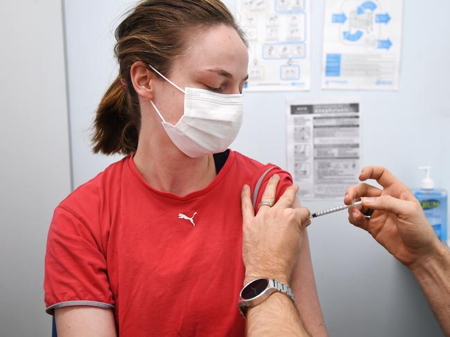 BRISBANE, AUSTRALIA - NewsWire Photos - AUGUST 8, 2021. 26 year-old Betsy Rutledge receives the AstraZeneca Covid-19 vaccine by pharmacist Michael Thorp at the Carina Day and Night pharmacy in Brisbane. Picture: NCA NewsWire / Dan Peled