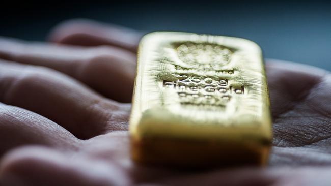 An employee holds a two hundred and fifty gram gold bar in this arranged photograph at Solar Capital Gold Zrt. in Budapest, Hungary, on Thursday, March 10, 2016. Gold advanced to the highest level in a year after the European Central Bank indicated it wouldn't cut interest rates further, boosting the euro and making dollar-denominated bullion less expensive for investors. Photographer: Akos Stiller/Bloomberg