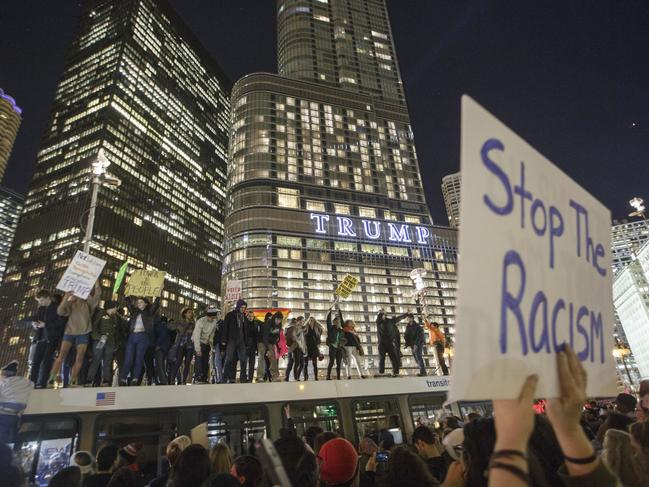 Demonstrators protest on top of a bus outside of the Trump Tower November 9, 2016 in Chicago, Illinois. Picture: AFP