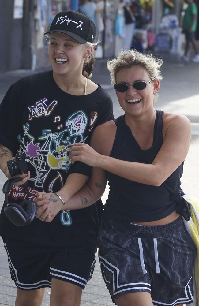 JoJo Siwa and her Aussie girlfriend Kath Ebbs get a serious case of the giggles as they spend the morning in Bondi. Picture: Media Mode