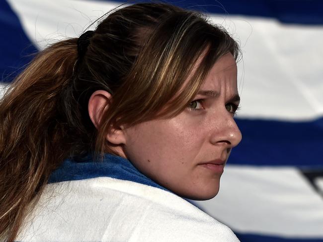 Protesters participate in a demonstration calling for a "No" vote in the forthcoming referendum on bailout conditions set by the country's creditors, in front of the Greek parliament in Athens on June 29, 2015. Greece shut its banks and the stock market and imposed capital controls after creditors at the weekend refused to extend the country's bailout past the June 30 deadline, prompting anxious citizens to empty ATM's. AFP PHOTO / ARIS MESSINIS