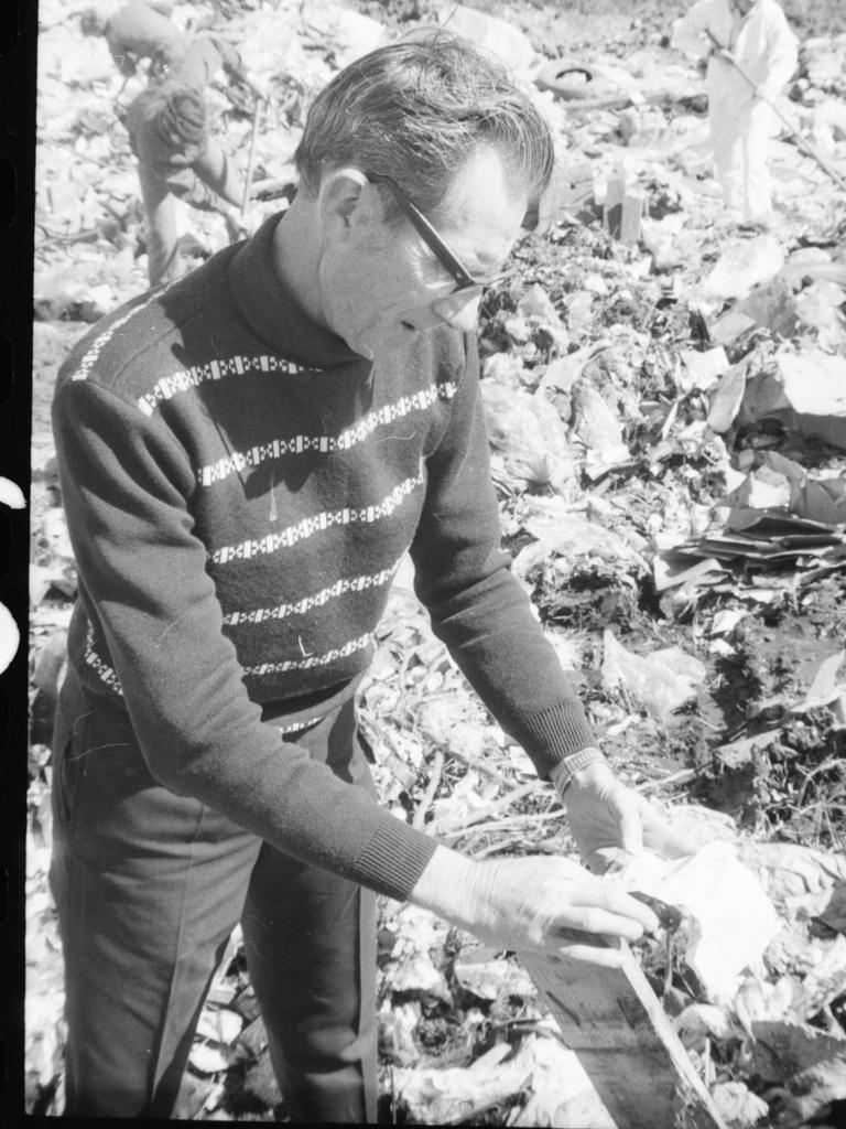 . Police looking through rubbish during the investigation into the death of Rex Keen.