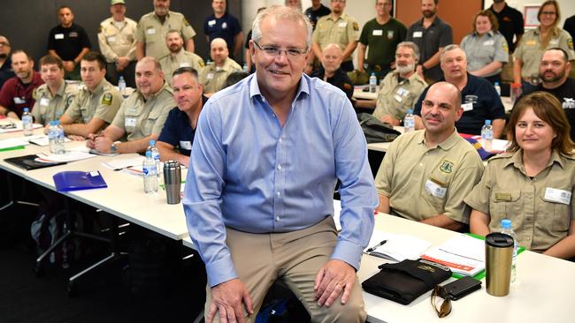 Prime Minister Scott Morrison greets firefighters from Canada at the NSW RFS control room. Picture: AAP/Joel Carrett