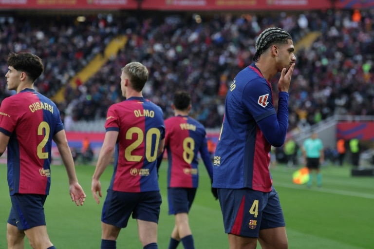 Barca thrash 10-man Real Sociedad to reclaim top spot