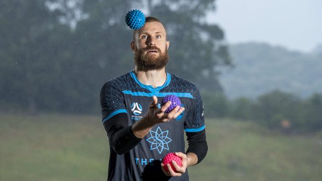 Sydney FC goalie Andrew Redmayne juggles before he goes out to play to keep his reflexes sharp.