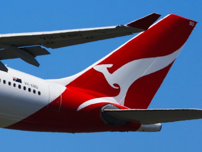 SYDNEY, AUSTRALIA - FEBRUARY 22: The tail of a Qantas plane is seen at take off from Sydney International Airport on February 22, 2024 in Sydney, Australia. Qantas has demonstrated a significant financial turnaround, reporting a record $2.47 billion profit for the 2022-23 fiscal year, marking a stark change from the previous year's $1.86 billion loss. The airline's strong performance was attributed to robust travel demand and high ticket prices, with domestic earnings before interest and taxes (EBIT) jumping to 18.2%, representing a 50% increase in profit margins over the past six years. The company's return on invested capital also increased to 103.6%, reflecting its improved financial position and operational performance. (Photo by Jenny Evans/Getty Images)