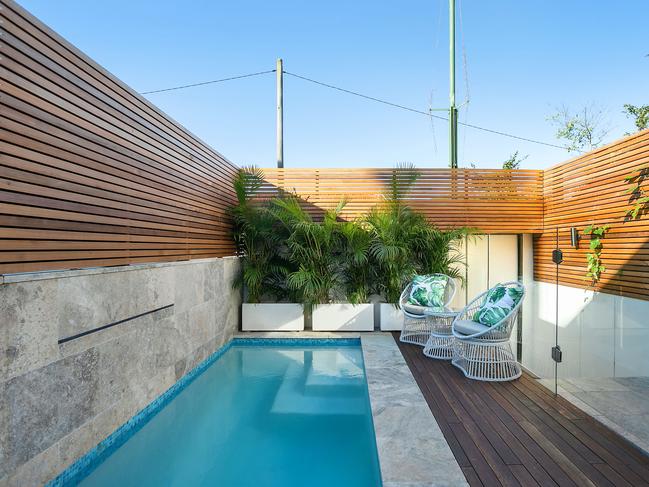 The backyard has a swimming pool and a hidden garage.