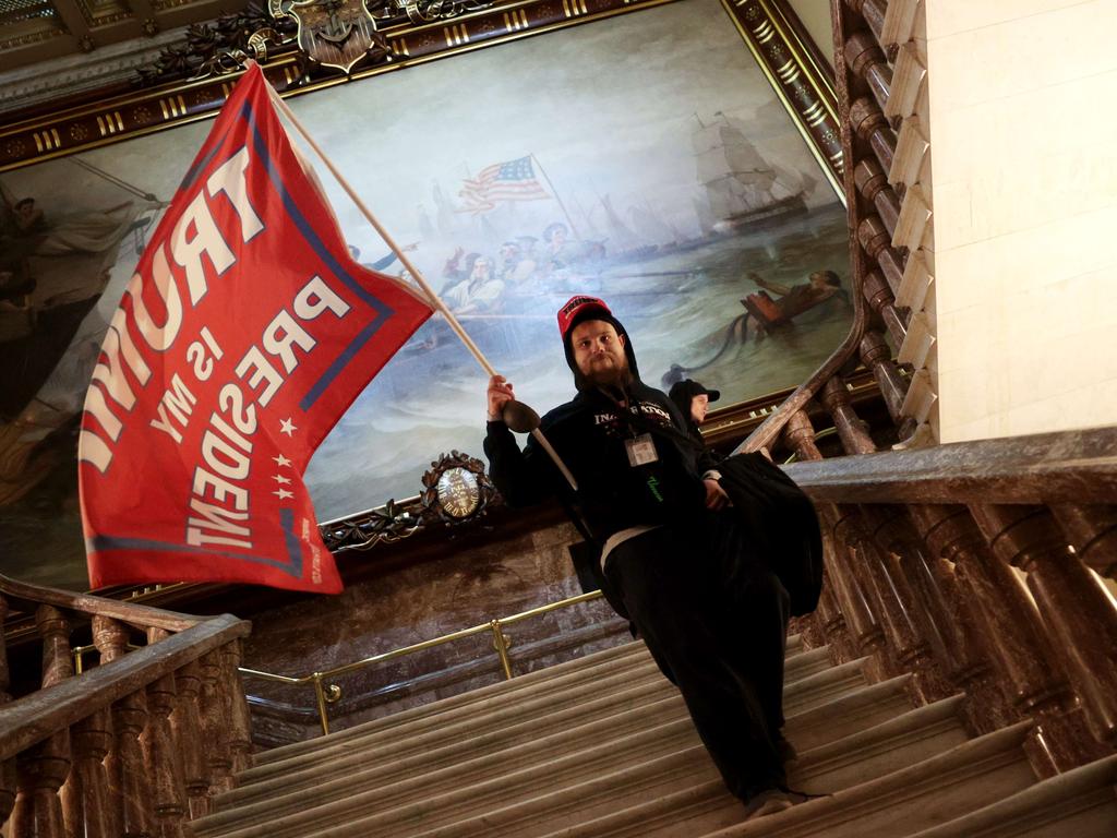 A protester holds a Trump flag inside the US Capitol Building near the Senate Chamber. Picture: AFP