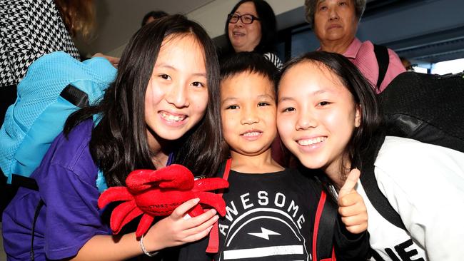 Wuhan evacuees Tina Wang (12), Aaron Fernandez (5) and Anna Wang (14) get ready to leave Christmas Island after spending two weeks at North West Point detention centre. Picture: Colin Murty