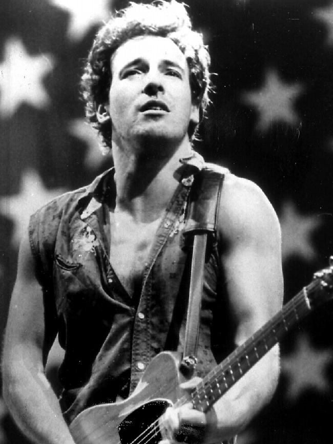 Springsteen plays his guitar in front of an American flag singing "Born in the USA" Picture: AP