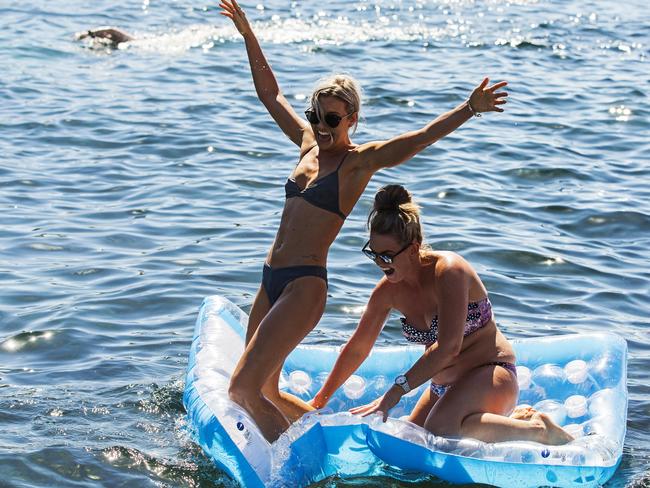 Jacqui Wilson (left) and Susie Bell escaped the heat at Clovelly yesterday and more crowds are expected at Sydney beaches today. Picture: Jenny Evans