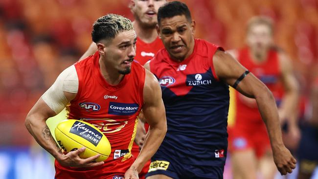 Gold Coast Sun Izak Rankine runs away from the Demons defence in Saturday’s match at Giants Stadium in Sydney. Picture: Getty Images