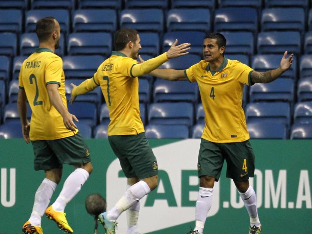 Socceroos (from left) Ivan Franjic, Mathew Leckie and Tim Cahill celebrate a goal against Ecuador in March, 2014. Picture: AFP / Ian Kington