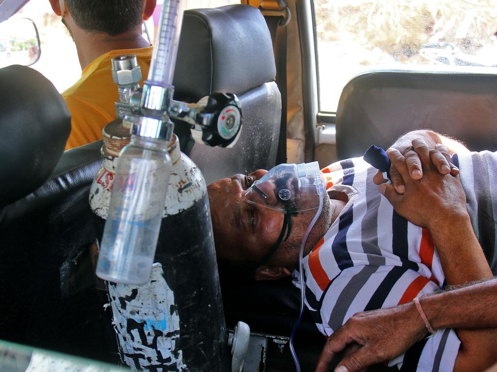 A COVID-19 patient waits in an ambulance outside at RUHS College of Medical Sciences Hospital in Rajasthan, India. Picture: Vishal Bhatnagar/NurPhoto via Getty Images