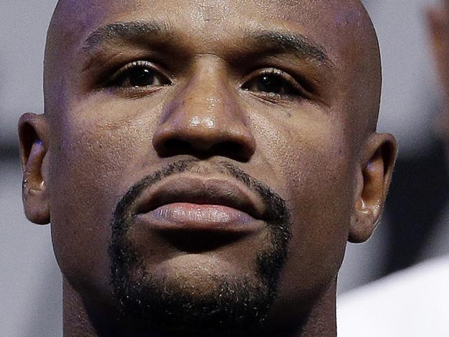 FILE - In this Sept. 12, 2014, file photo, Floyd Mayweather Jr. poses on the scale during a weigh in for a fight against Marcos Maidana in Las Vegas. Mayweather Jr. said Wednesday, June 14, 2017,  he will come out of retirement to face UFC star Conor McGregor in a boxing match on Aug. 26. Mayweather, who retired in September 2015 after winning all 49 of his pro fights, will face a mixed martial arts fighter who has never been in a scheduled 12-round fight at the MGM Grand arena. The fight will take place in a boxing ring and be governed by boxing rules.  (AP Photo/John Locher, File)