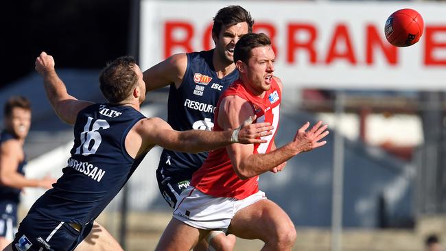 North Adelaide’s Cameron Craig breaks away under pressure from South Adelaide's Jordan Taylor. Picture: Tom Huntley