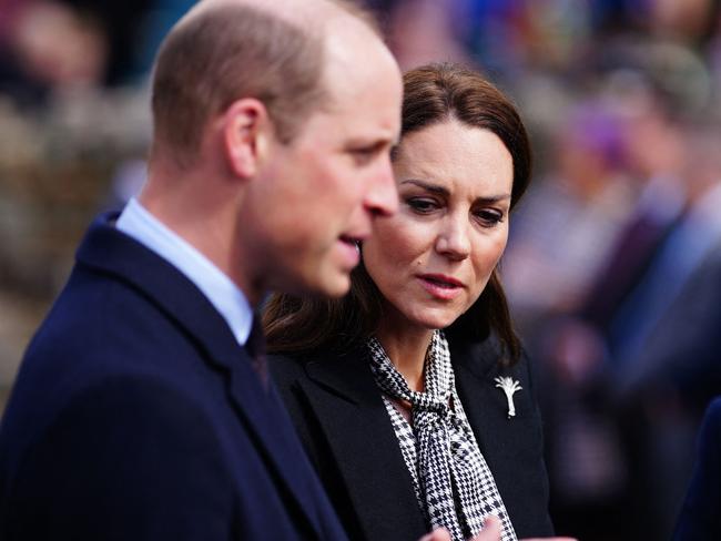 Britain's Prince William, Prince of Wales (L) and Britain's Catherine, Princess of Wales (C) visit the Aberfan memorial garden in Aberfan, south Wales on April 28, 2023, to pay their respects to those who lost their lives during the Aberfan disaster on October 21, 1966. - The garden sits on the site of the Pantglas school which was tragically destroyed in a coal-tip landslide on 21st October 1966. The incident led to the loss of 144 lives, including 116 children. (Photo by Ben Birchall / POOL / AFP)