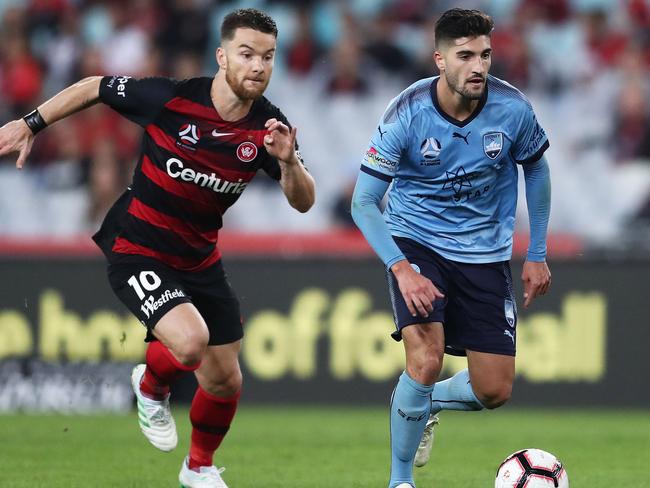 Sydney FC’s Paulo Retre is challenged by Western Sydney Wanderers’ Alexander Baumjohann on Saturday night. Picture: Getty Images