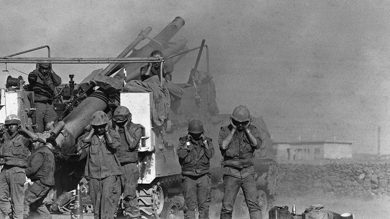 Israeli soldiers plug their ears as they fire shells from a French-made 155mm Horwitzer gun at the Syrian front lines during the Yom Kippur War. Picture: AFP