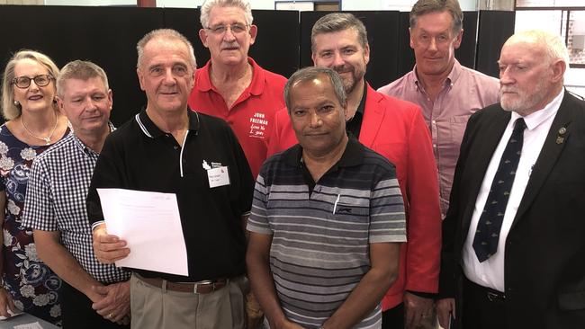 Seven of the eight Logan City Council mayoral candidates with Returning Officer Ray Langler, holding the finalised ballot card. Pictured: Sherry Heath, Brett Raguse, Ray Langler, John Freeman, Paul Taylor, Stewart Fleming, Darren Power and Allan de Brenni. PHOTO: JUDITH KERR